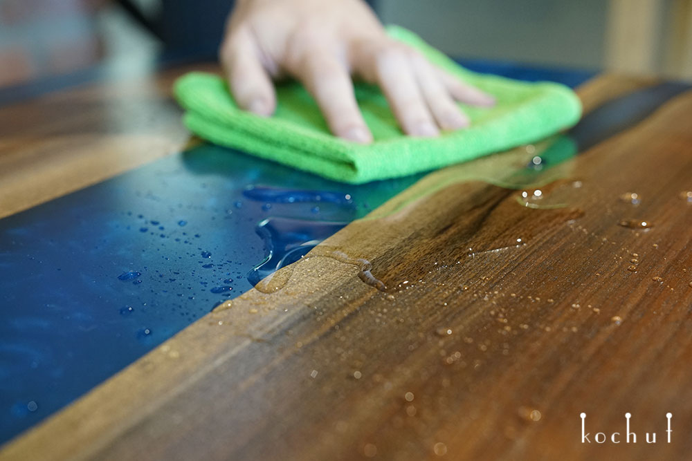 Cleaning an epoxy river table with alcohol.